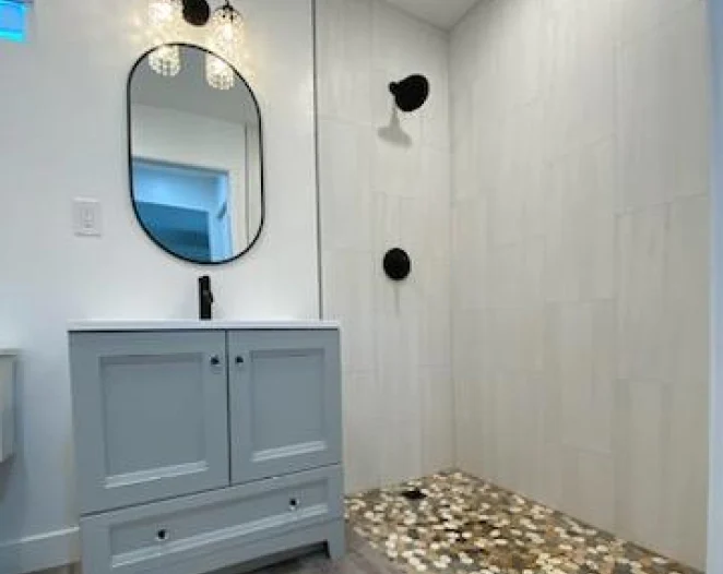 light grey bathroom with light blue cabinets